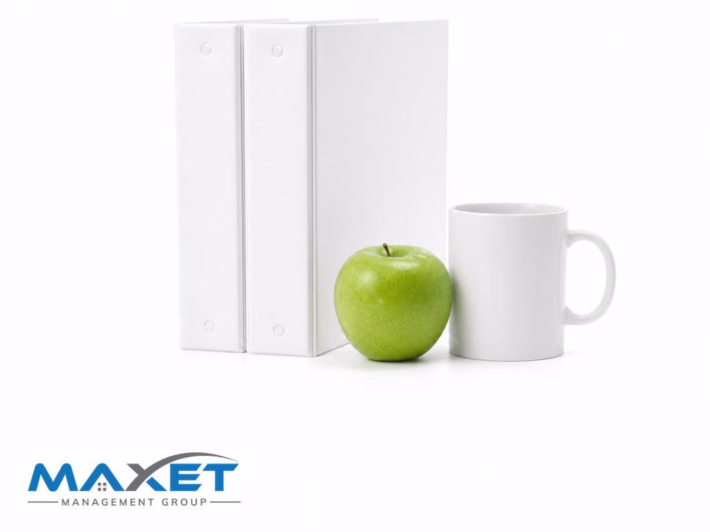 Two blank white binders and a green apple on a bright white surface representing the comparison between Florida Statute 720 and 718 reserve requirements
