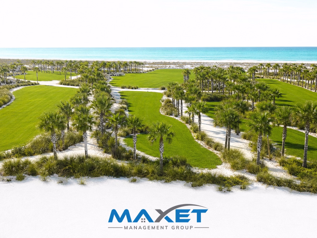 Aerial view of a new planned community landscape with green grass strips and young palm trees in coastal Northwest Florida