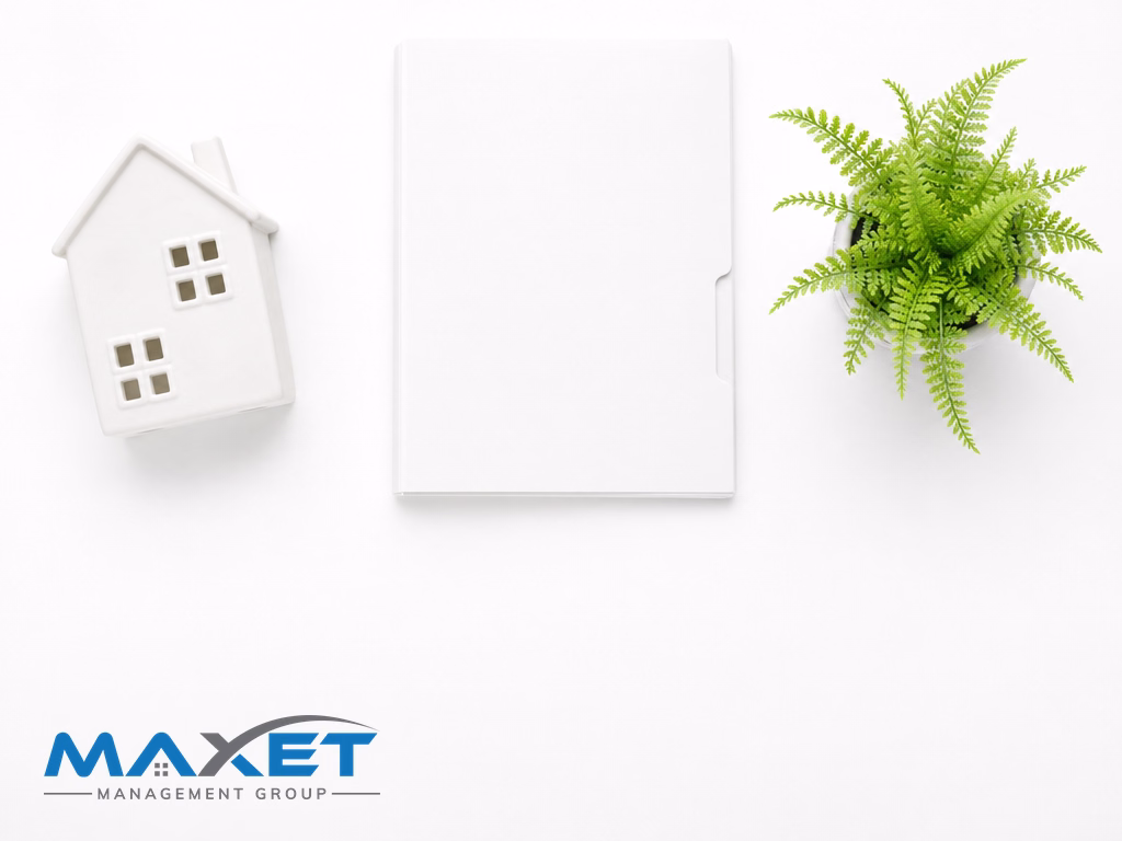 White ceramic house figurine, blank folder, and green fern representing community association contractor proposal review